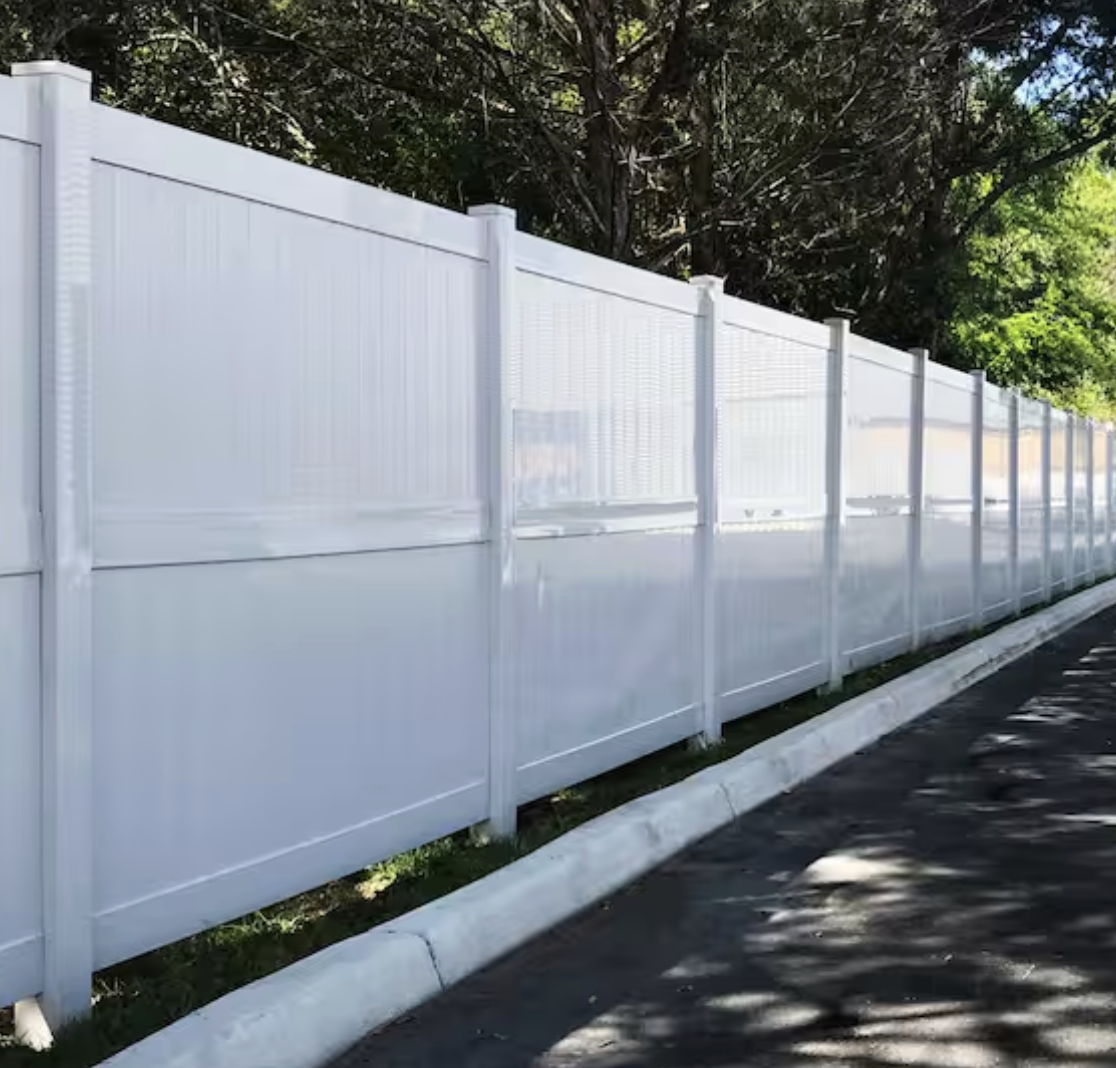 8 foot tall white vinyl privacy fence along a driveway