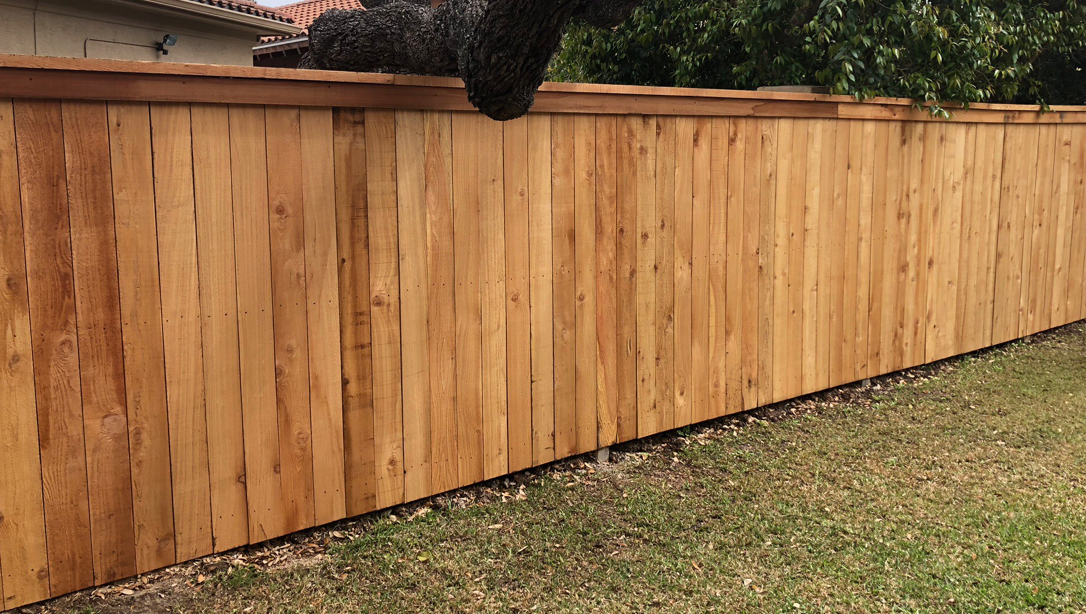 Smooth-faced redwood fence with trim